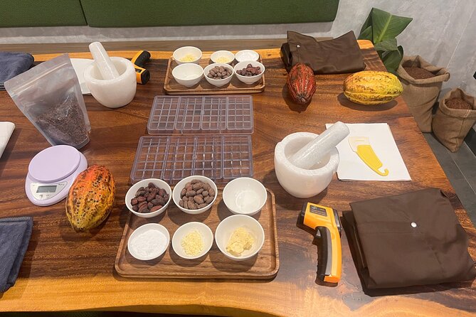 Bean to bar Chocolate Workshop in Ho Chi Minh City - Grinding cacao paste the traditional way with granite